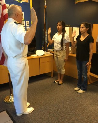 Lemoore High senior bound for Prep School and U.S. Naval Academy Lemoore High School NJROTC Instructor Lt. Cmdr. John Wolstenholme swears Jackylyn Domingo into the Navy.
